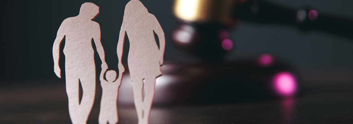 Family figure and gavel on table