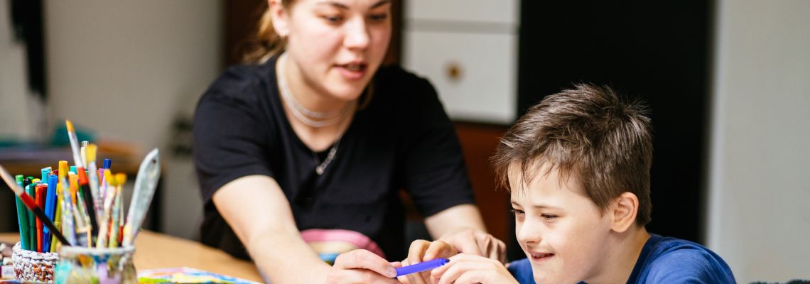 Disabled child with teacher in school