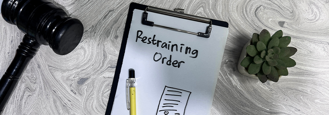 Concept of Restraining Order write on paperwork isolated on Wooden Table