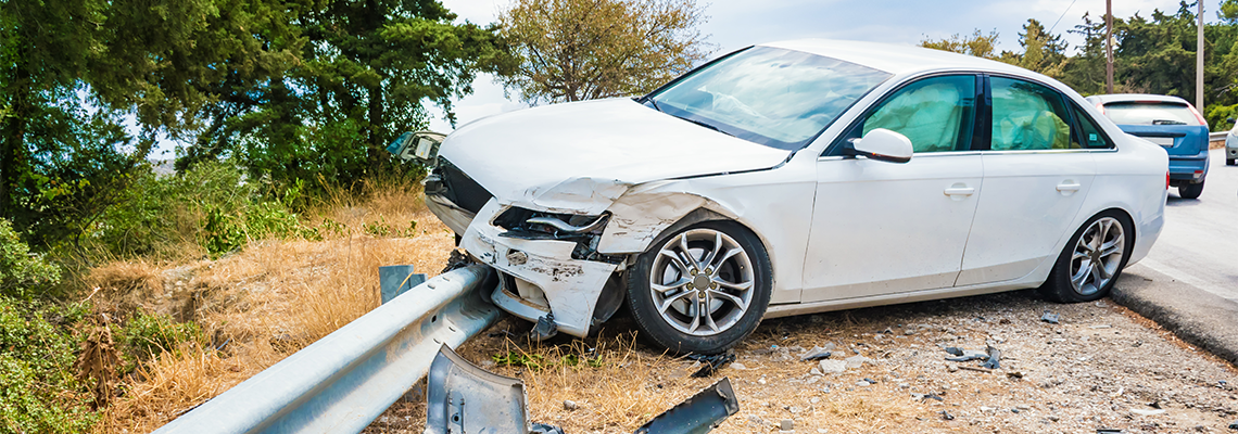 Crashed car with deflated airbags after accident finished on road