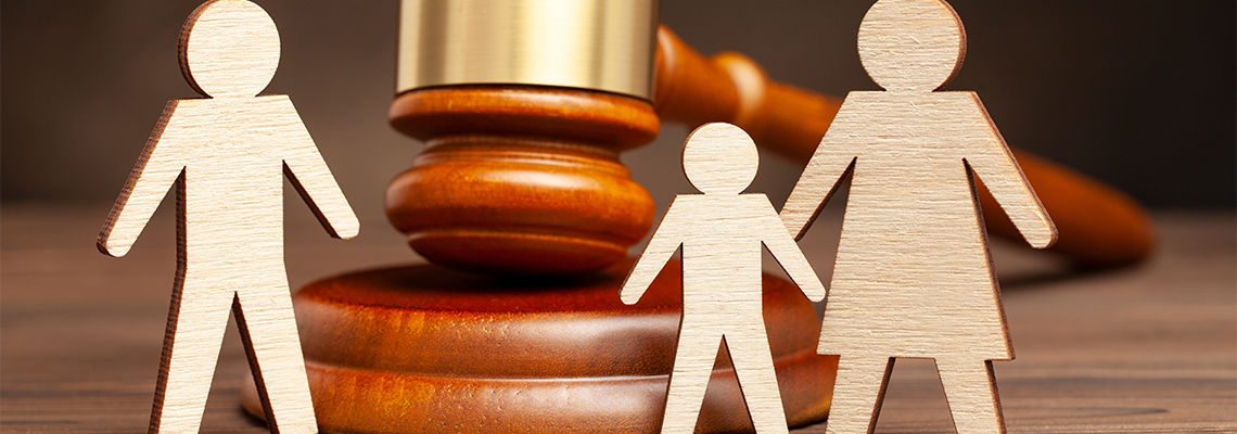 Model of Mother with child apart from father and judge's hammer