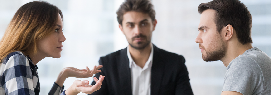 Spouses split up disputing about divorce settlement in lawyers office