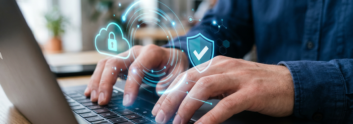 Cybersecurity protection concept with person typing on laptop