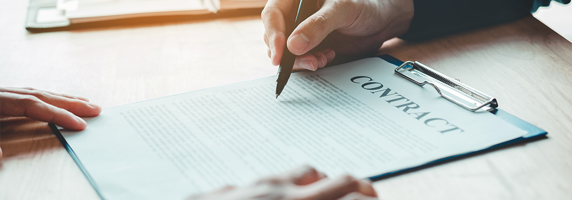 Business people negotiating a contract between two colleagues