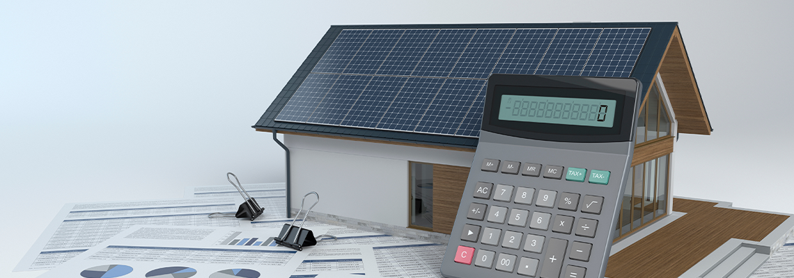 House with photovoltaic solar panel and calculator and documents