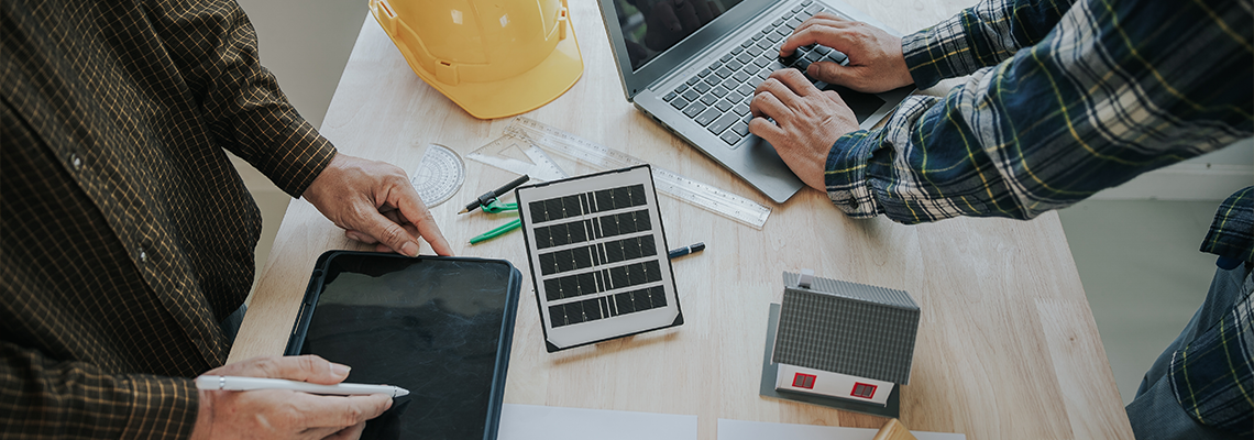 Engineer and contractor planning to install solar panel on building rooftop