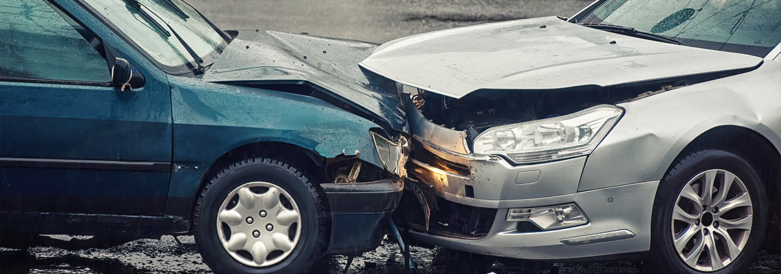 Car accident on wet road during rain, head on collision side view