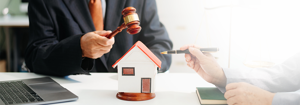 Lawyer handling house foreclosure law with gavel and home model