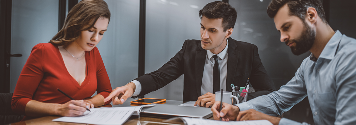 Professional lawyer consulting spouses about legal documents