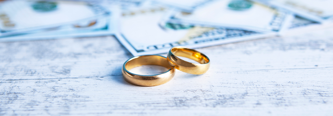 Money wedding rings and divorce documents on table