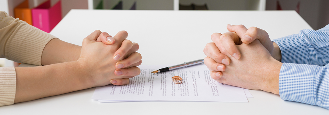 Couple going through divorce signing papers