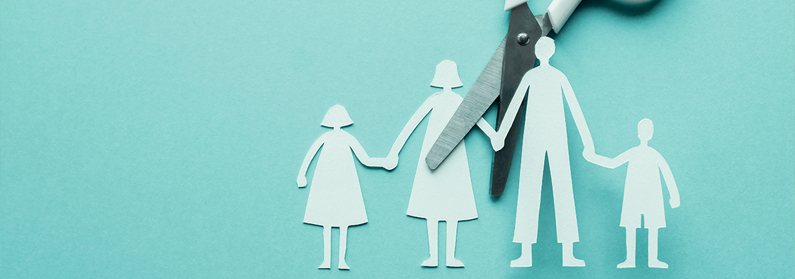 White scissor cutting family paper cut out on blue background