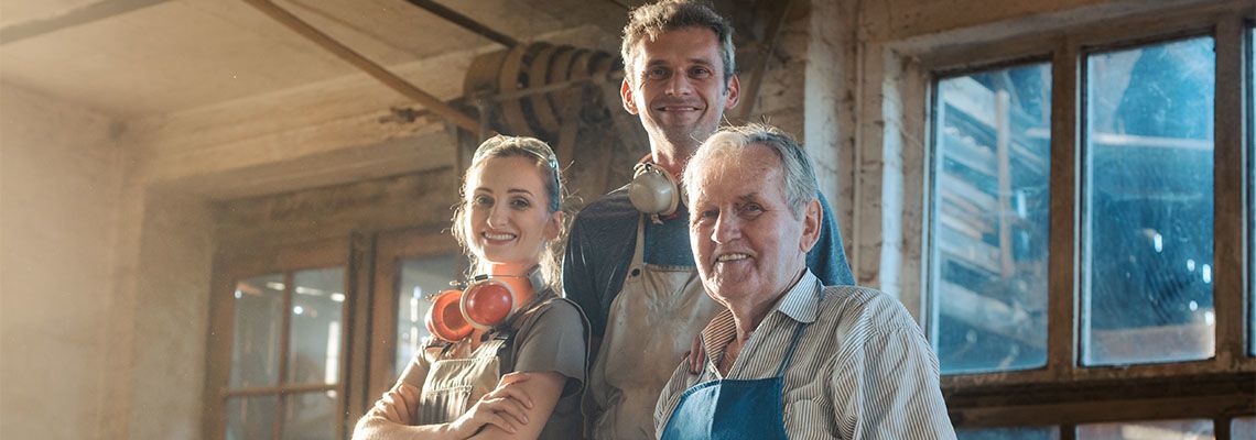 Generations of carpenters in their family business workshop