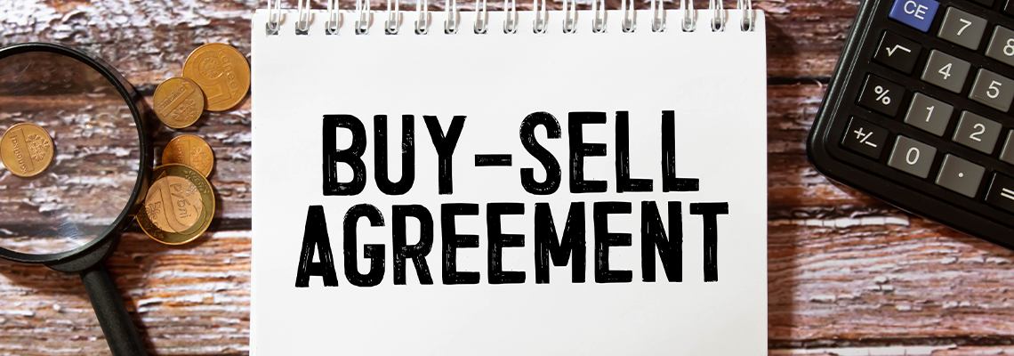 Text Buy-Sell Agreement on white paper, business concept