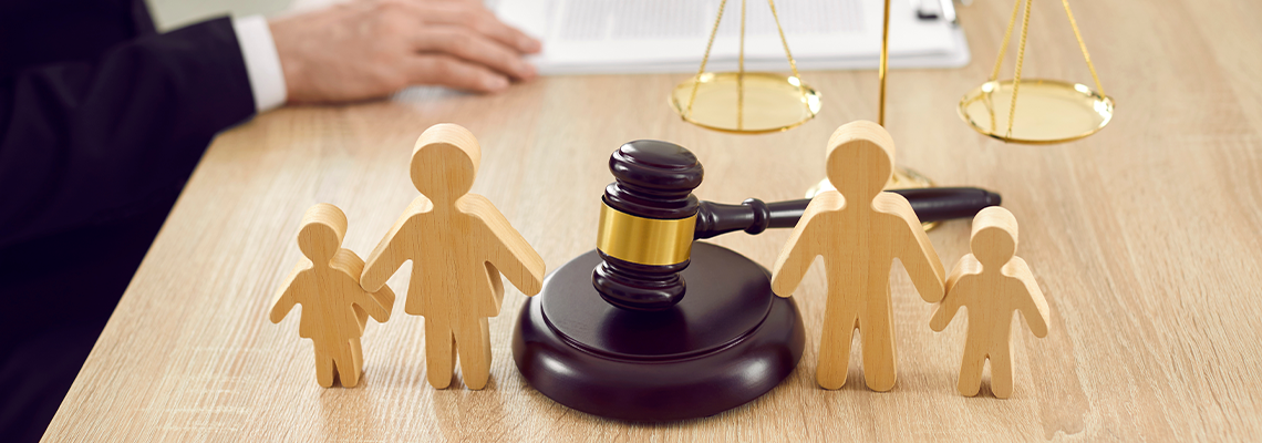 Figures of family are separated by judge's gavel, which symbolizes family law