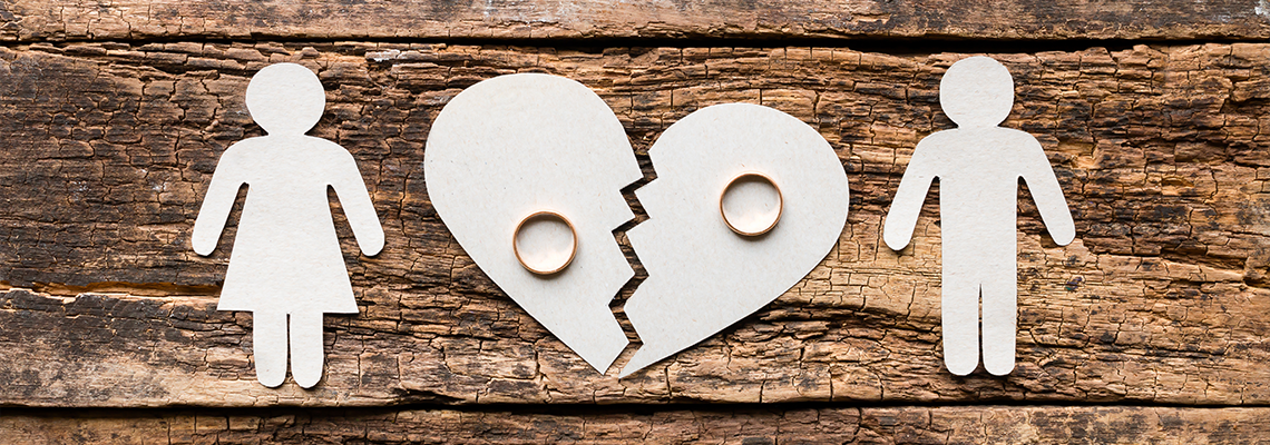 Paper family near a broken heart a divorce