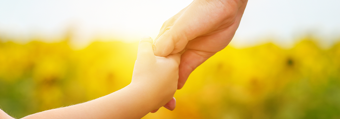 Hands of mother and daughter