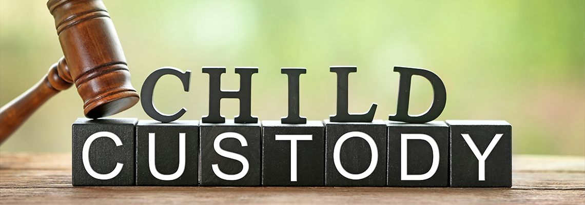 Text CHILD CUSTODY made of black blocks and letters with judge gavel on table