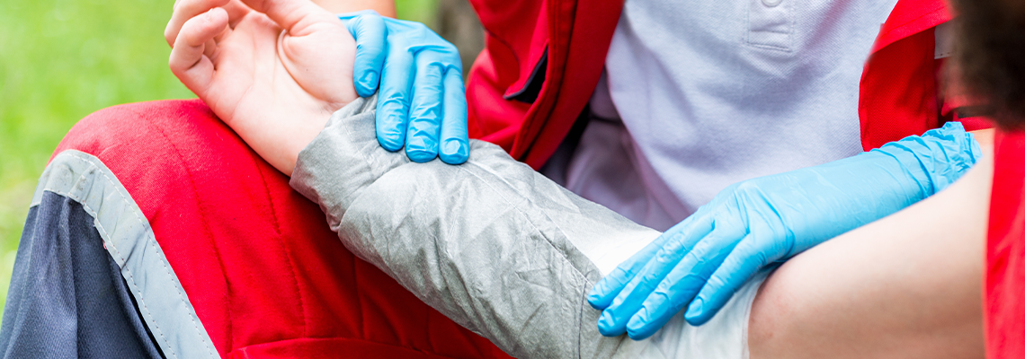 Paramedic placing bandage after burn injury