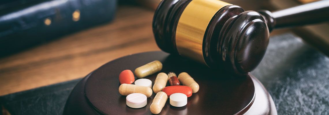 Gavel and drugs on table