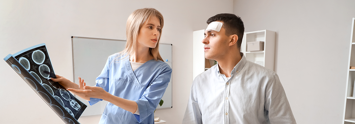 Female doctor and man with brain concussion examining MRI
