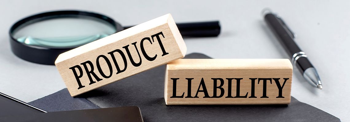PRODUCT LIABILITY text on wooden block on black notebook