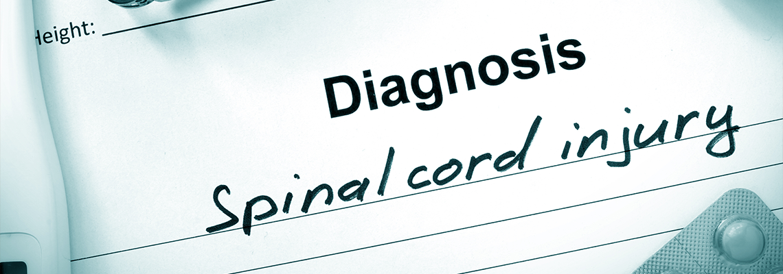 Diagnosis Spinal cord injury and tablets on a wooden table