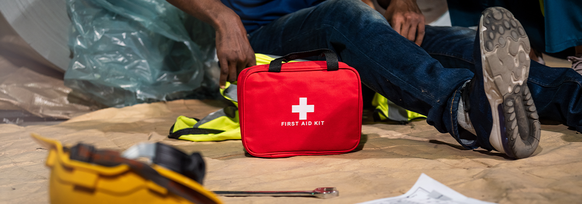 Emergency staff in safety suit use first aid kit to help a man who has an accident