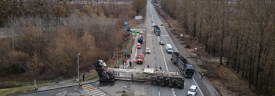 Aerial view of road accident with overturned truck blocking traffic