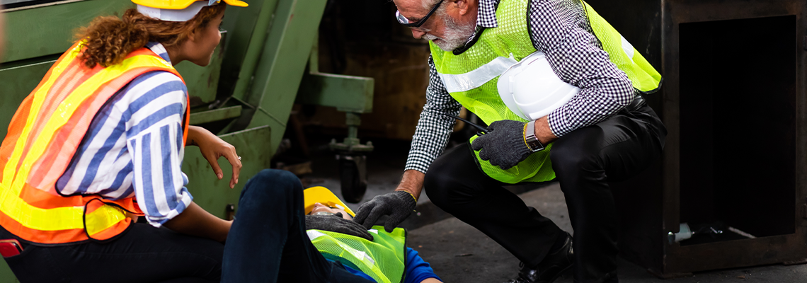 Engineering supervisor talking on walkie talkie while his coworker lying unconscious y