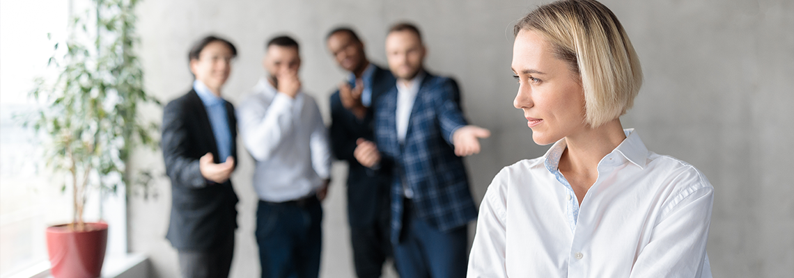 Male Coworkers Whispering Behind Unhappy Victimized Business Lady