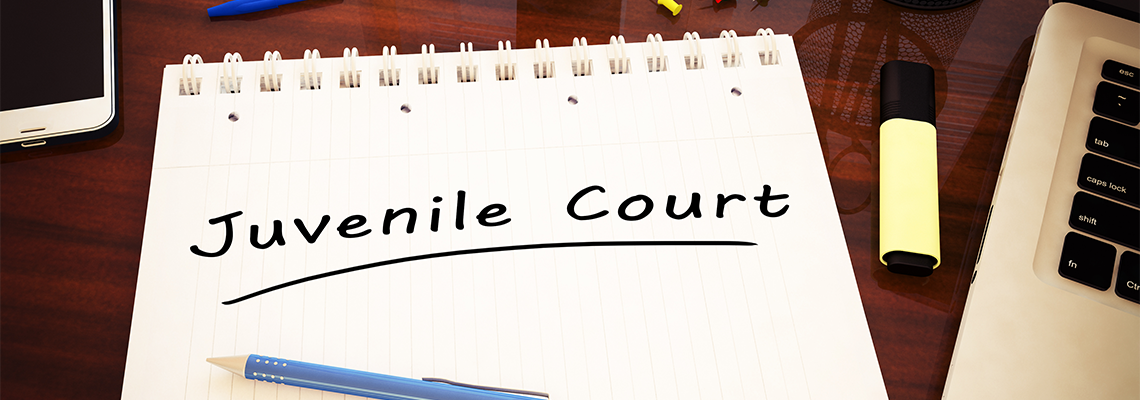 Juvenile Court Written on Notepad with Pen