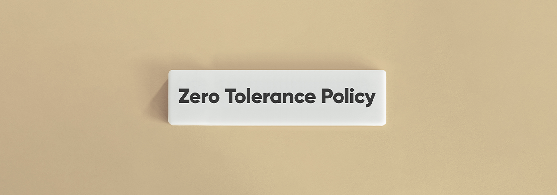 Zero Tolerance Policy Text on White Tile with Beige Background