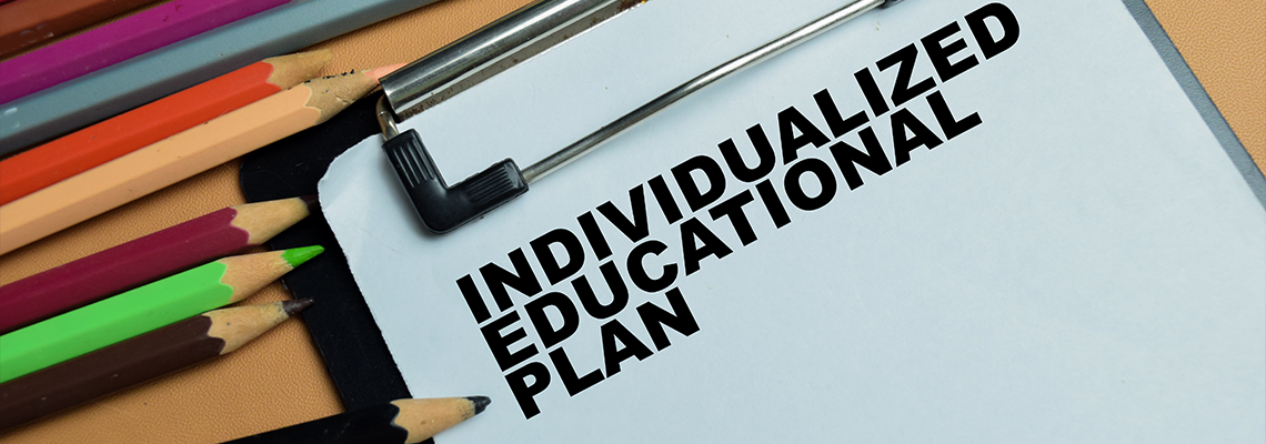 Concept of individualized educational plan write on clipboard isolated on table