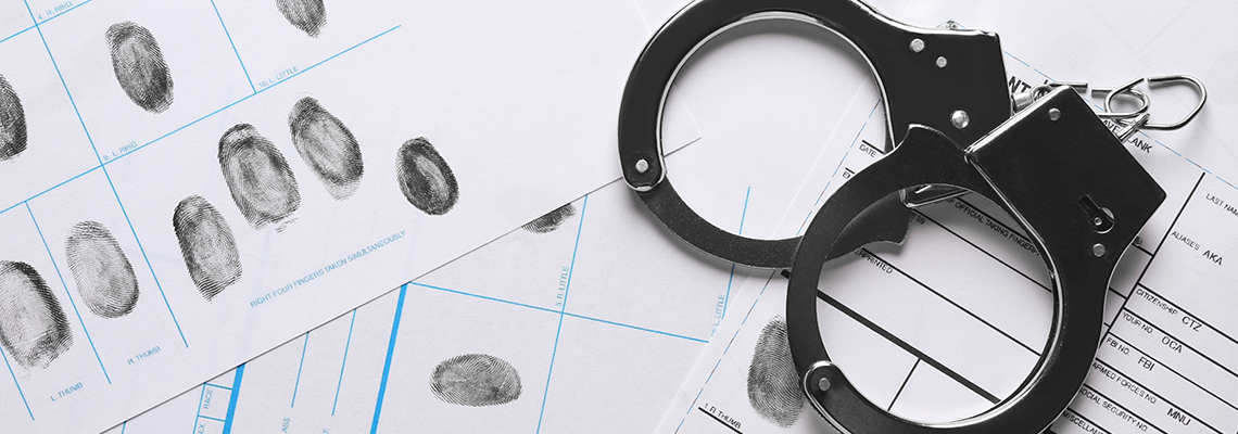 Handcuffs and fingerprint record sheets, top view