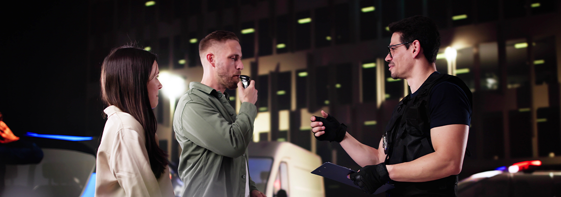 Police Officer Conducts Breath Test at a Road