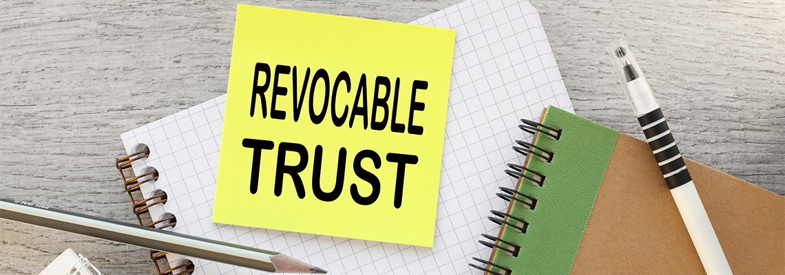 Revocable trust yellow sticker with text on the desktop near the calendar