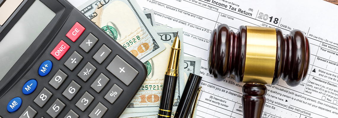Gavel with calculator and money on tax form