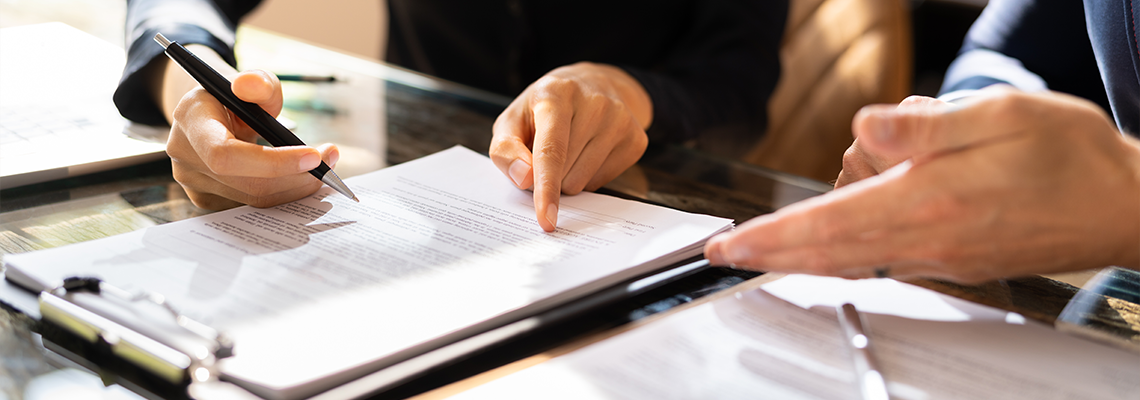 Two Businesspeople Working On Contract Paper
