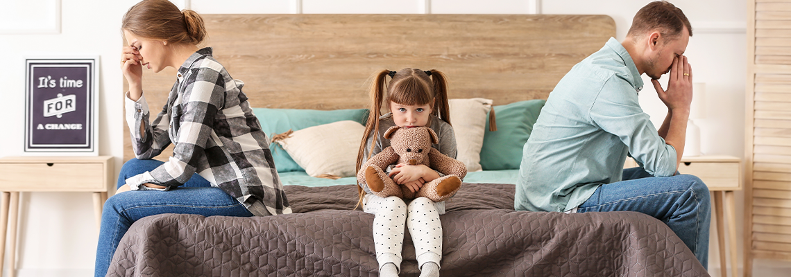 Sad family sitting on bed after quarrel