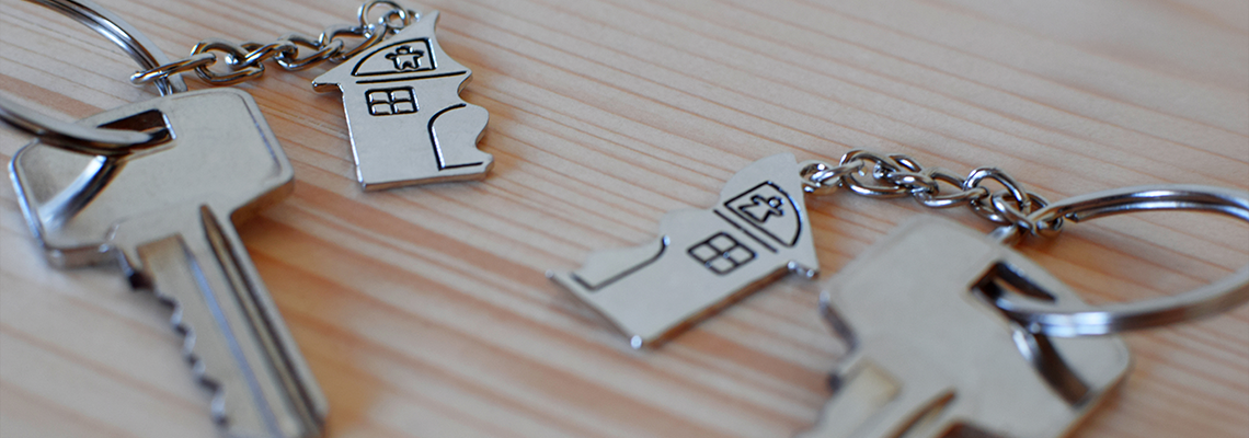 Two keys with splitted or broken key rings with pendant in shape of house