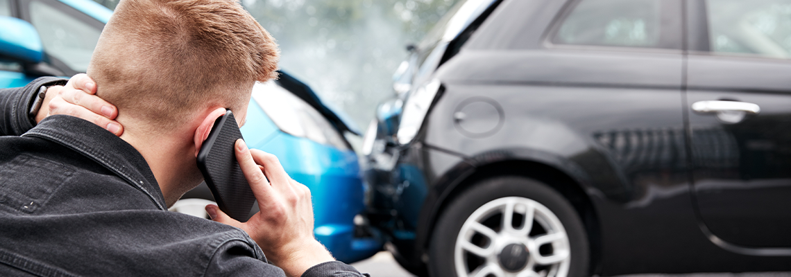 Male Motorist Involved In Car Accident Calling Insurance Company