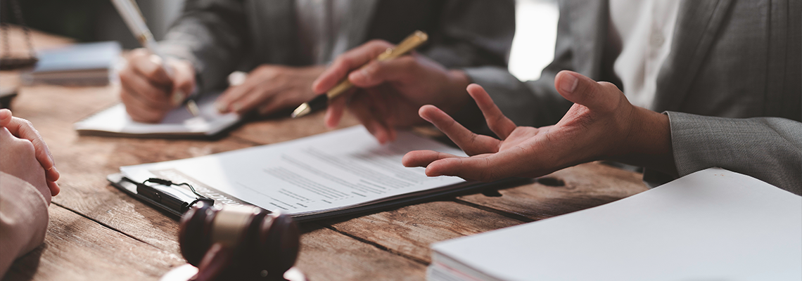 Lawyers discussing contract details during meeting in law firm
