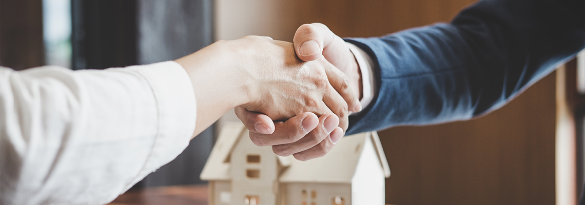 Estate agent and customer shaking hands after finished contract