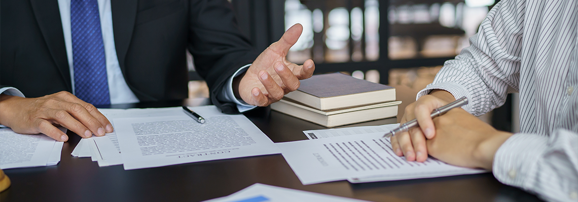 Lawyer Legal counsel presents to the client a signed contract with gavel