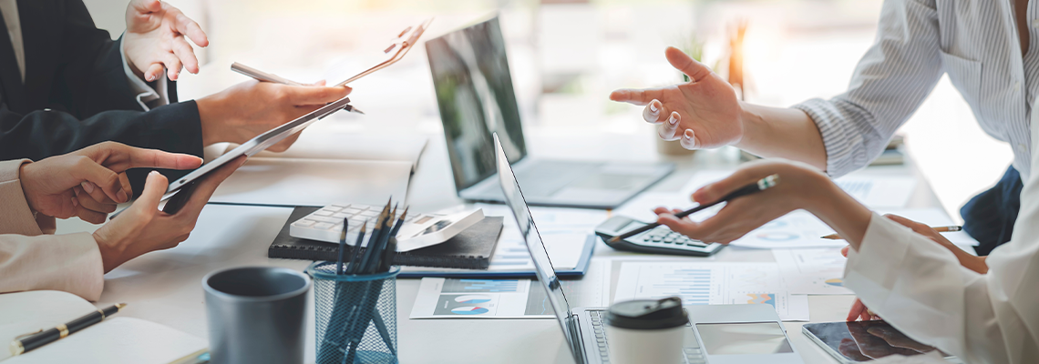 Diverse coworkers working together in boardroom, brainstorming