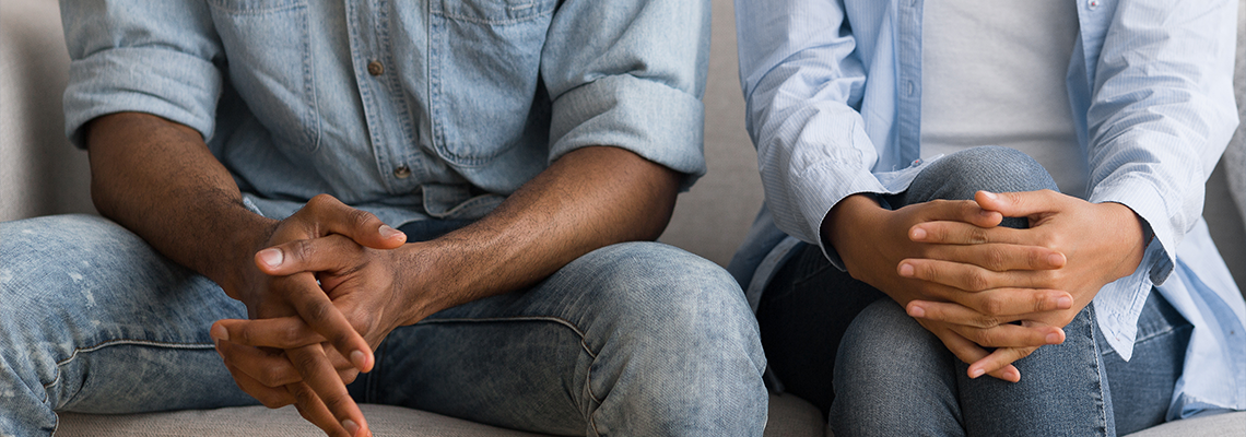 Unrecognizable Afro Couple Sitting On Couch At Marital Counselor's Office