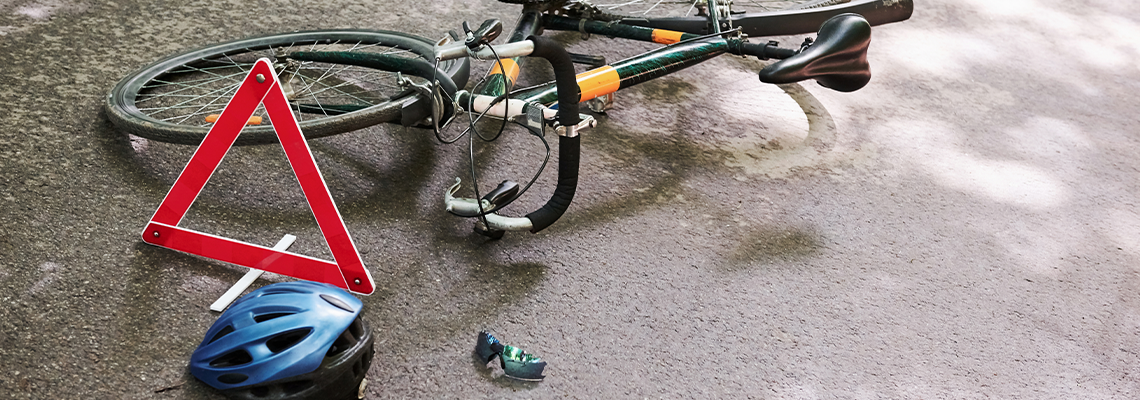 Bicycle accident on the road in forest at daytime