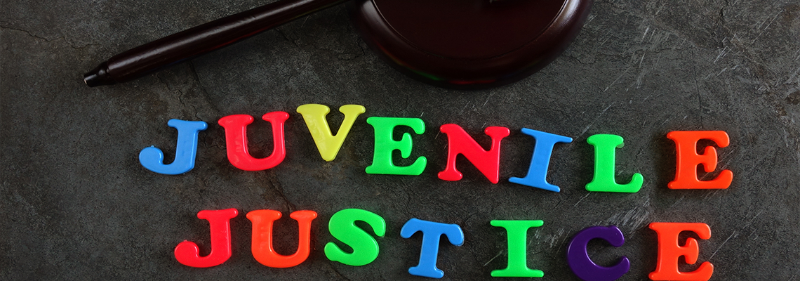 Juvenile Justice colorful text gavel on table
