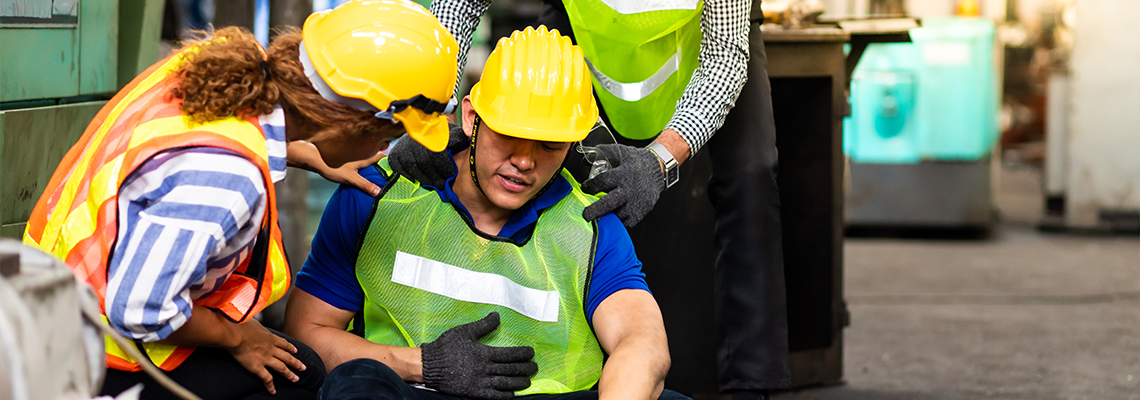 Person lying unconscious at industrial factory